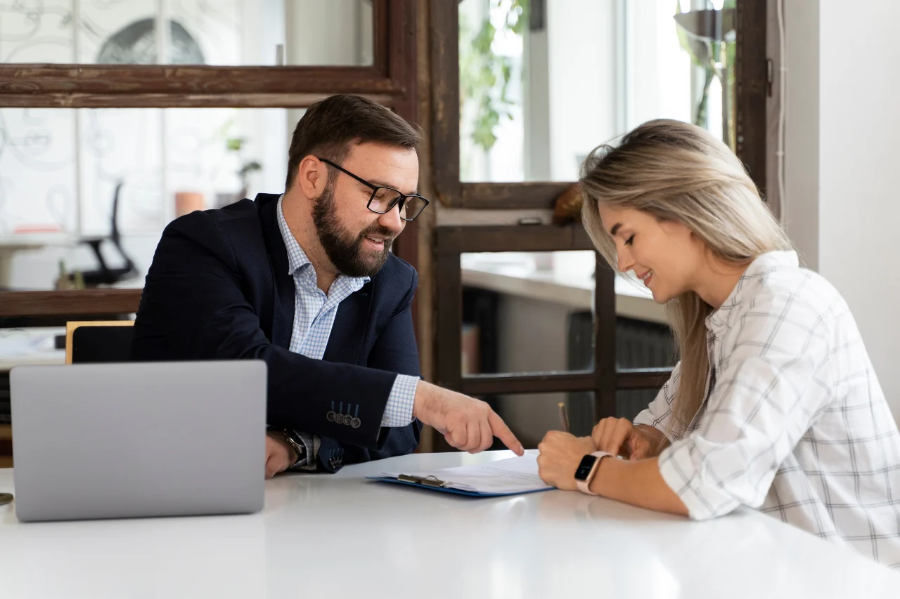 A financial advisor guiding a client through documents, highlighting accuracy, transparency, and financial confidence.