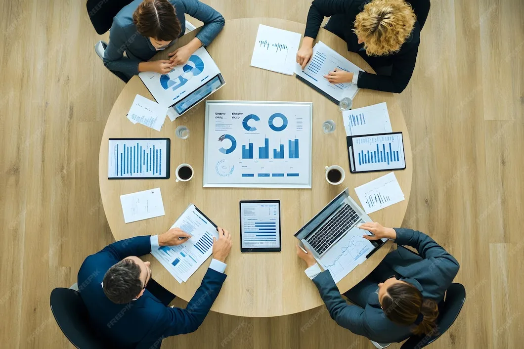 Business team reviewing financial reports during mergers and acquisitions planning.